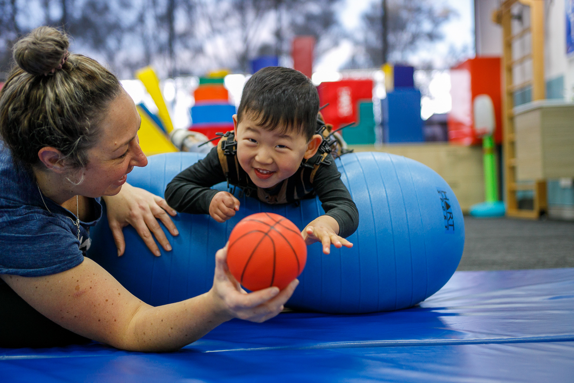 Paediatric occupational therapists supports a child using sensory toys. These can benefit toddlers and children with autism, sensory processing disorder, or honestly any child!