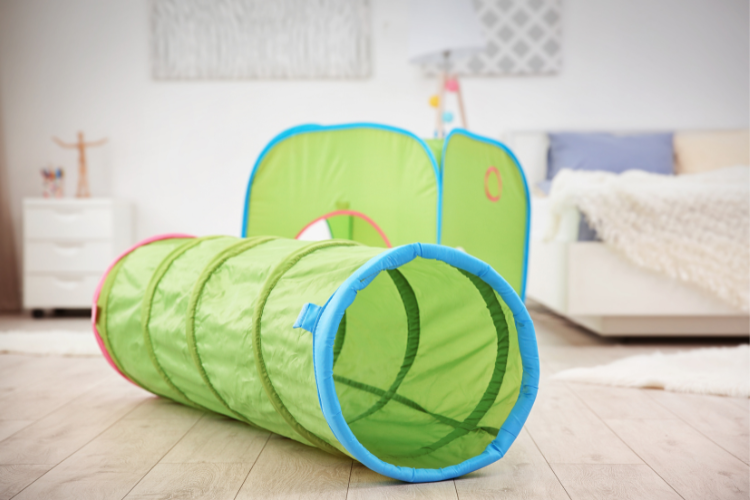 Tunnels are a great sensory toy for toddlers because they provide proprioceptive and vestibualar sensory input. Find more toys recommended by our occupational therapists in this blog!